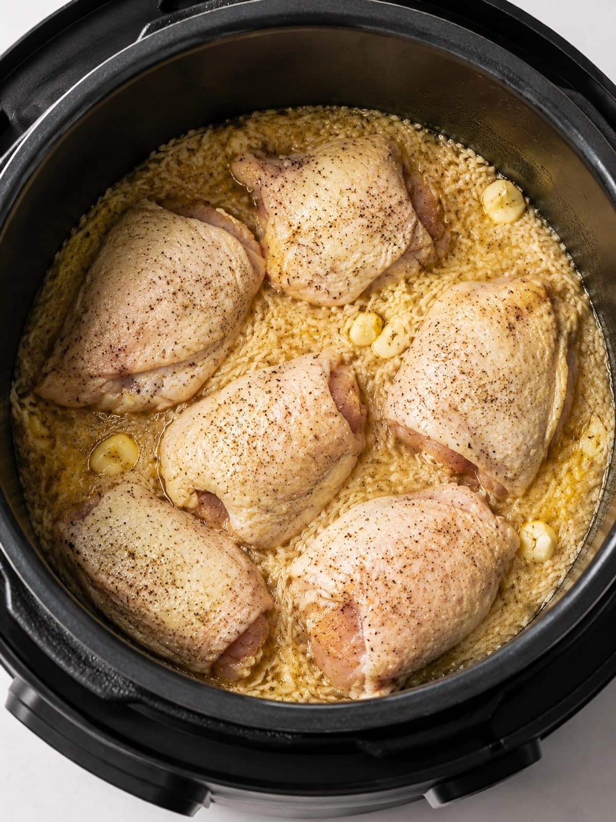 Instant Pot Lemon Chicken Rice and Peas: Load the cooker